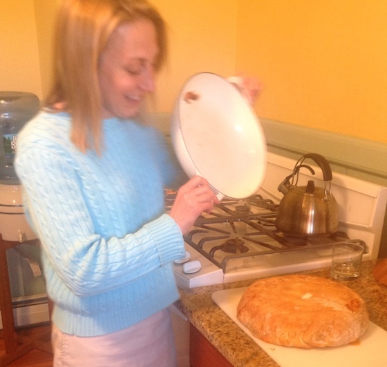 woman in blue sweater making timpano in the kitchen