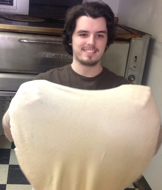 man holding pizza dough