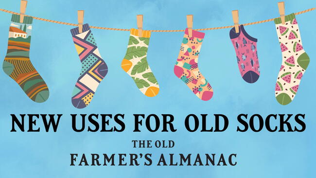 new uses for old socks, socks on a clothesline held up by clothespins