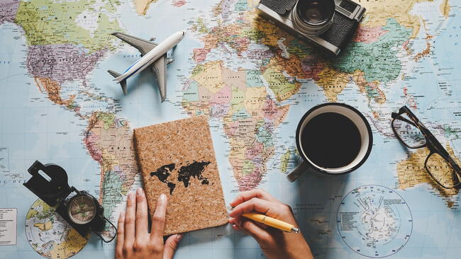 World map on desk with journal