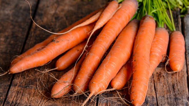 clean carrots on a wooden table