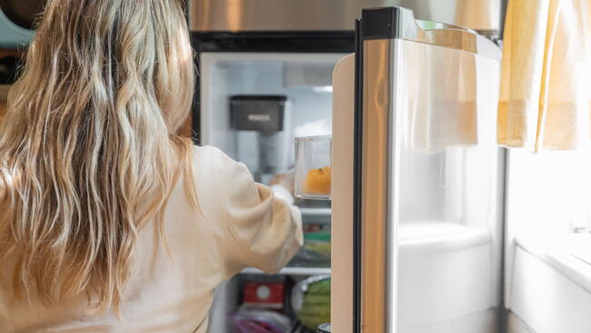 woman opening fridge