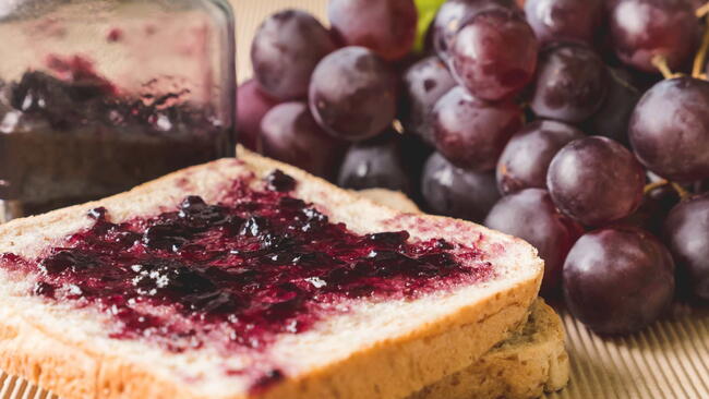 grape jelly on toast and in a jar with red grapes