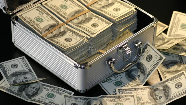 american dollar bills in a metal box