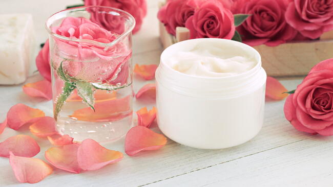 rose water and rose water cream. rose petals and fresh roses