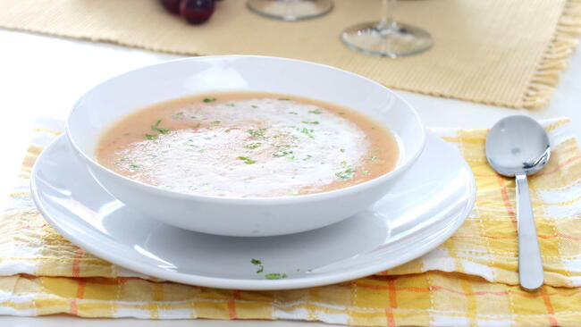 bellevue broth with a swirl of whipped cream and sprinkle of Chinese parsley