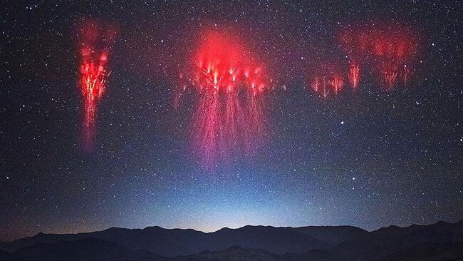 red sprites glowing in the sky above a thunderstorm