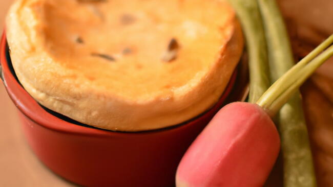 Turnip Souffle in a red ramekin with a turnip next to it