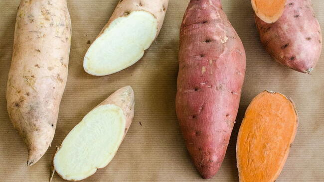 yam and a sweet potato, cut open to show the difference