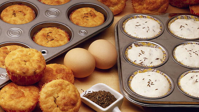 cooked and uncooked muffins in muffin pans