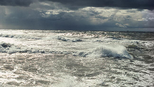 churning waves under stormy skies