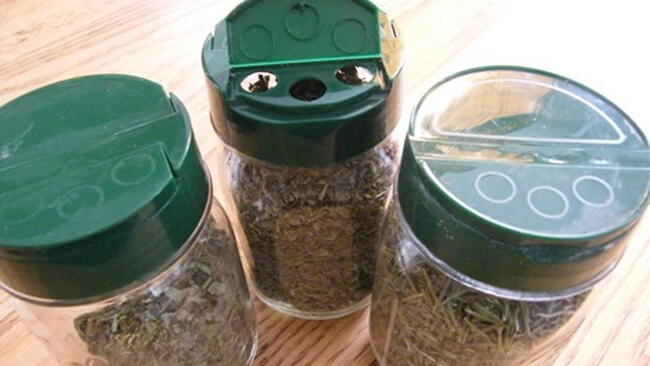 recycled parmesan cheese lids on bottles of bolts and screws
