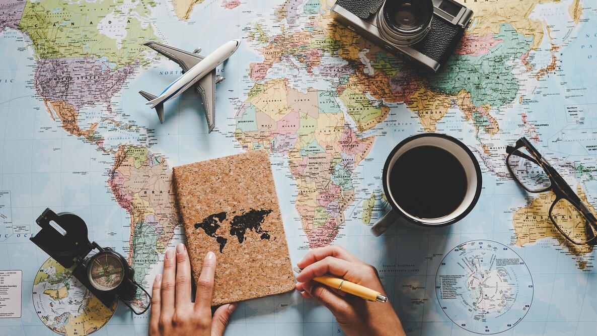 World map on desk with journal