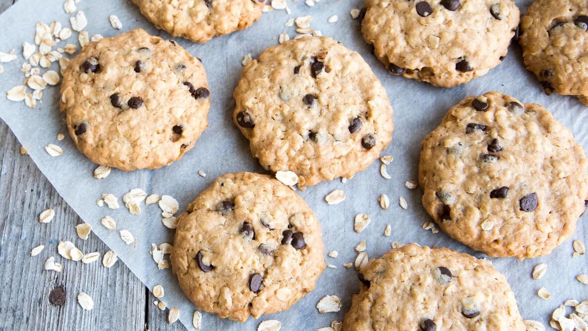 Cowboy cookies and oats on parchment paper