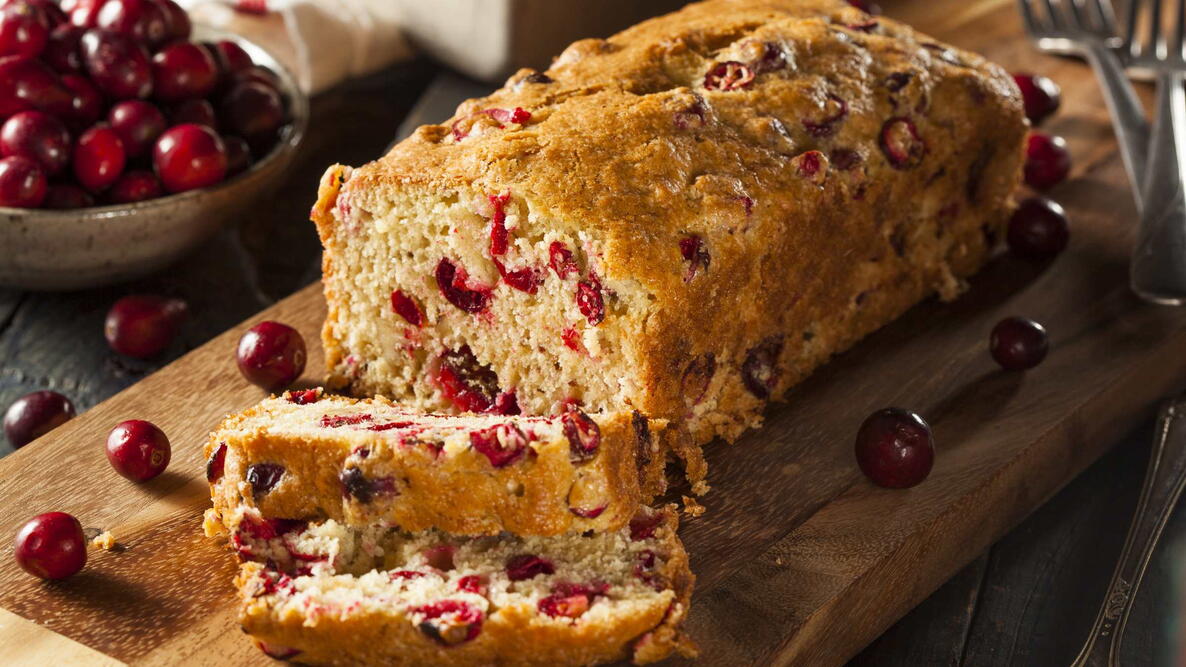 cranberry applesauce bread on a wooden cutting board