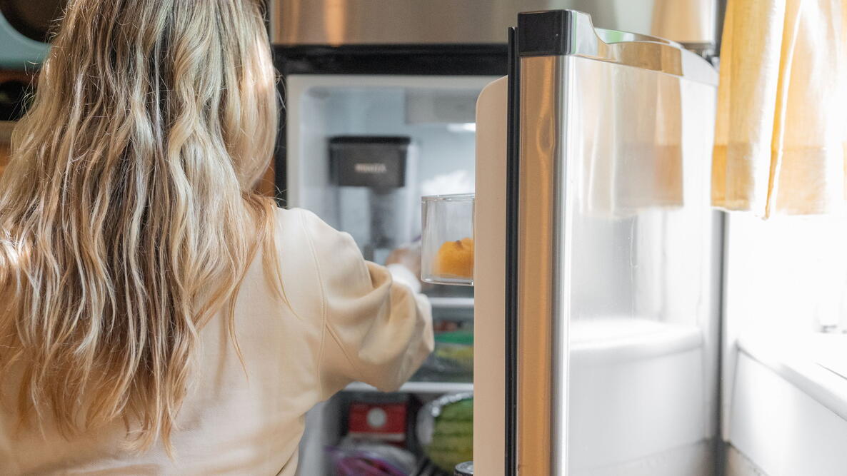 woman opening fridge
