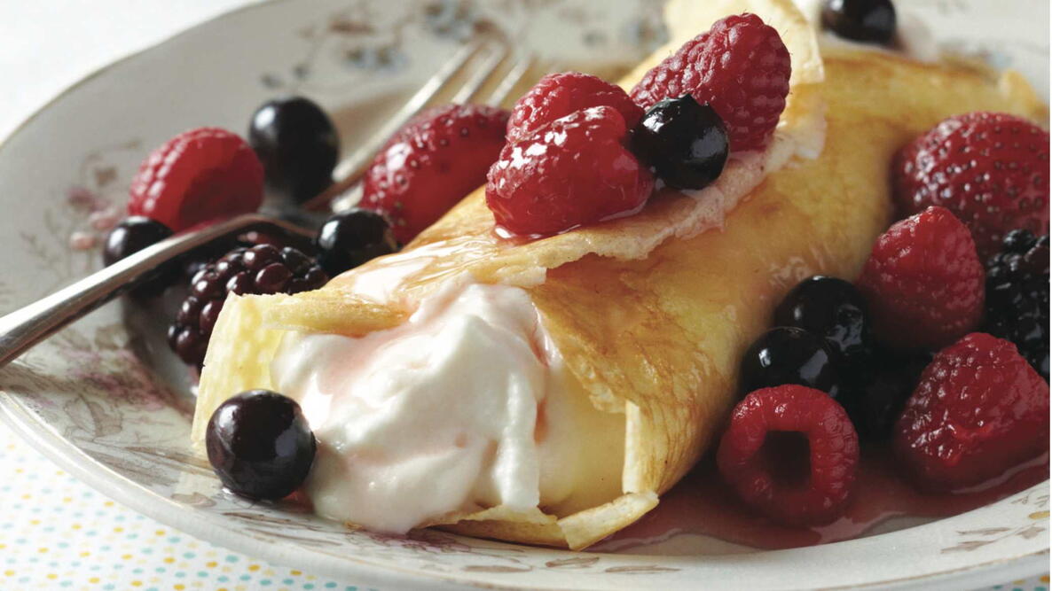crepes with whipped cream and berries