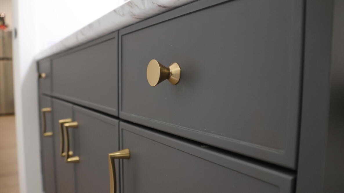 Gold Cabinet Hardware in white bathroom