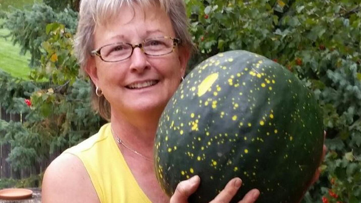 Woman holding a big green fruit