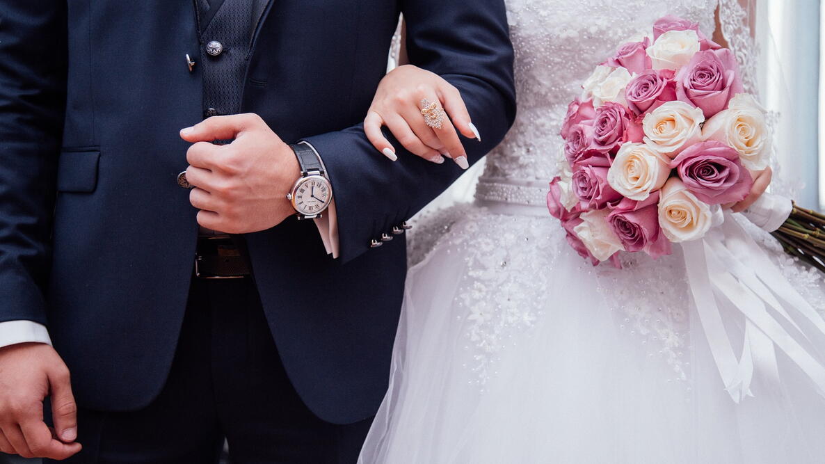 bride and groom linking arms on their wedding day