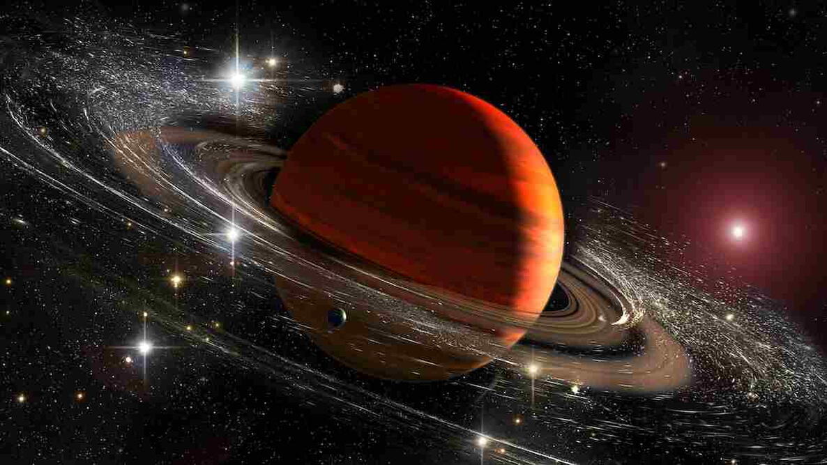Saturn planet with rings in outer space among star dust and stars