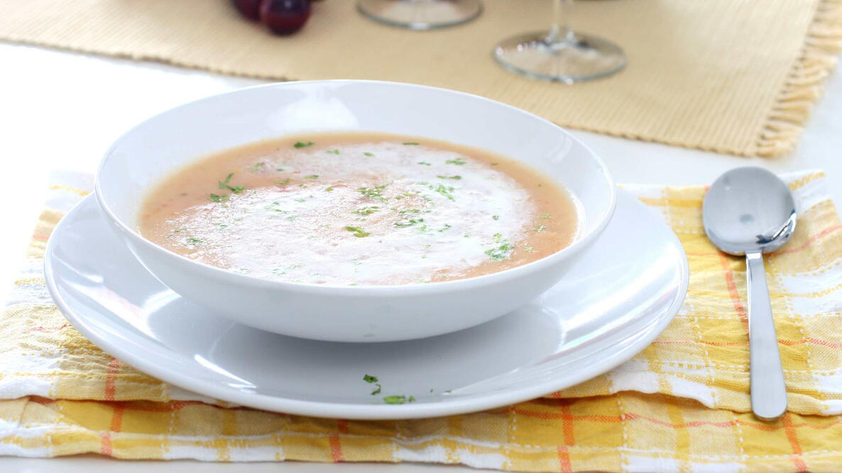 bellevue broth with a swirl of whipped cream and sprinkle of Chinese parsley