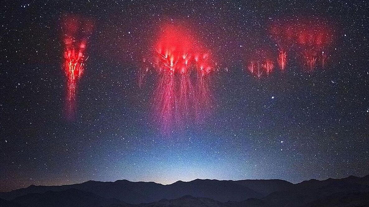 red sprites glowing in the sky above a thunderstorm