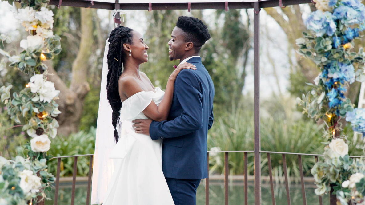 Wedding, dance and black couple in garden with love, celebration and excited future together. Gazebo, man and woman at luxury marriage reception with flowers, music and happiness at party in nature.