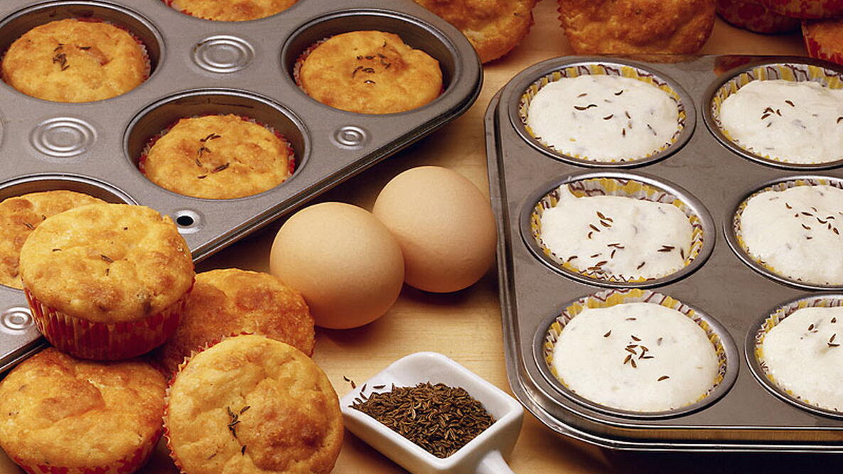 cooked and uncooked muffins in muffin pans
