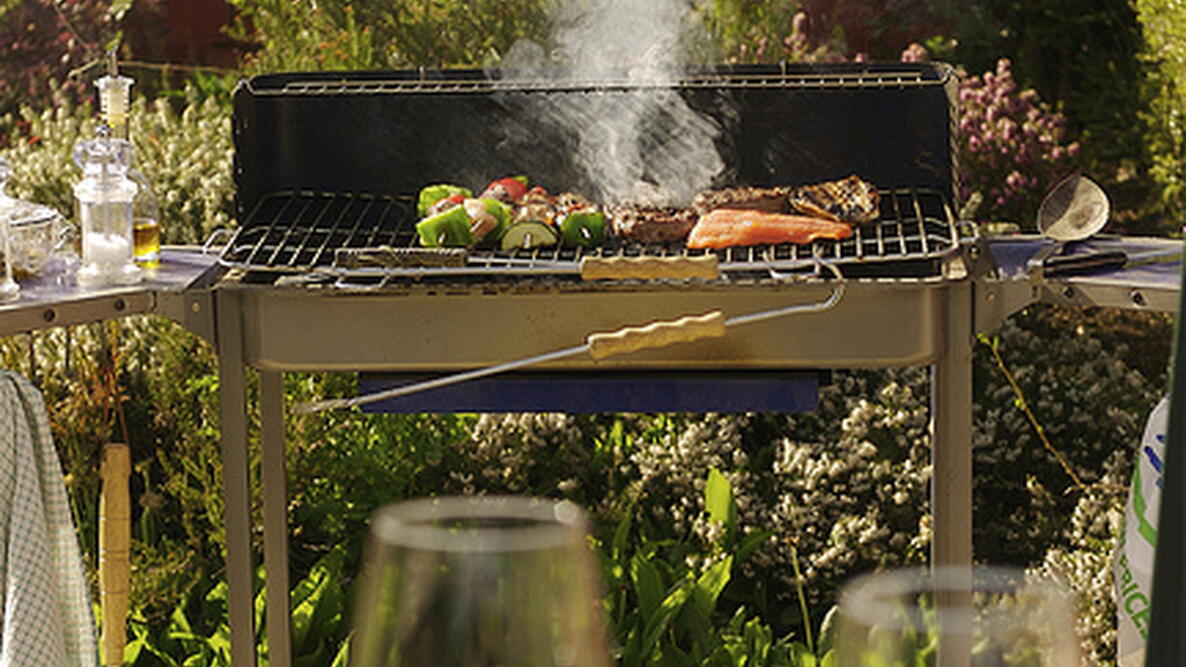 vegetable kebabs, meat and fish cooking on an outdoor grill
