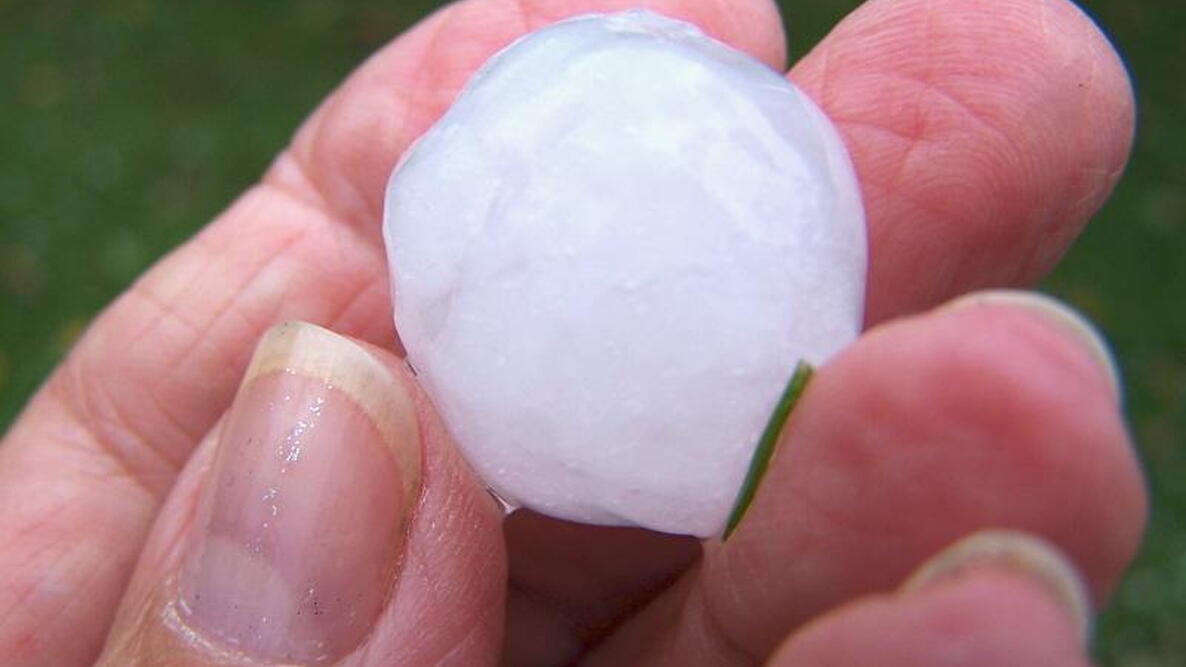 hailstone being held by a woman's hand