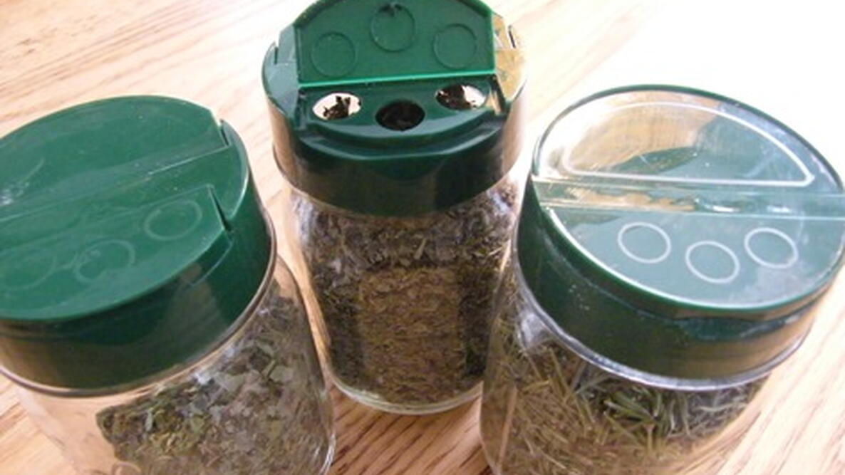 recycled parmesan cheese lids on bottles of bolts and screws