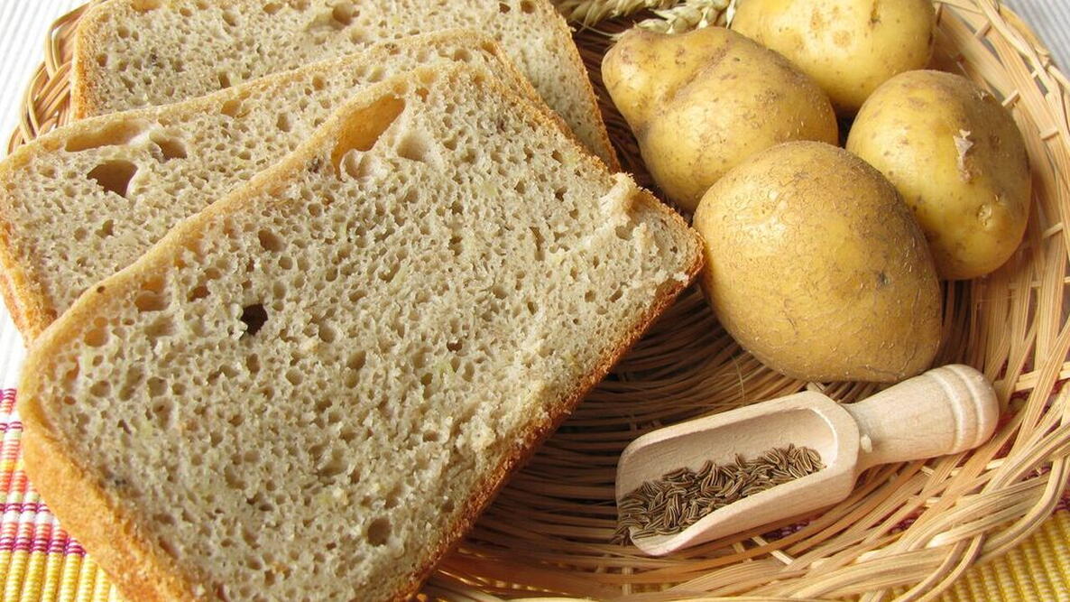 image of sliced bread, with potatoes and herbs