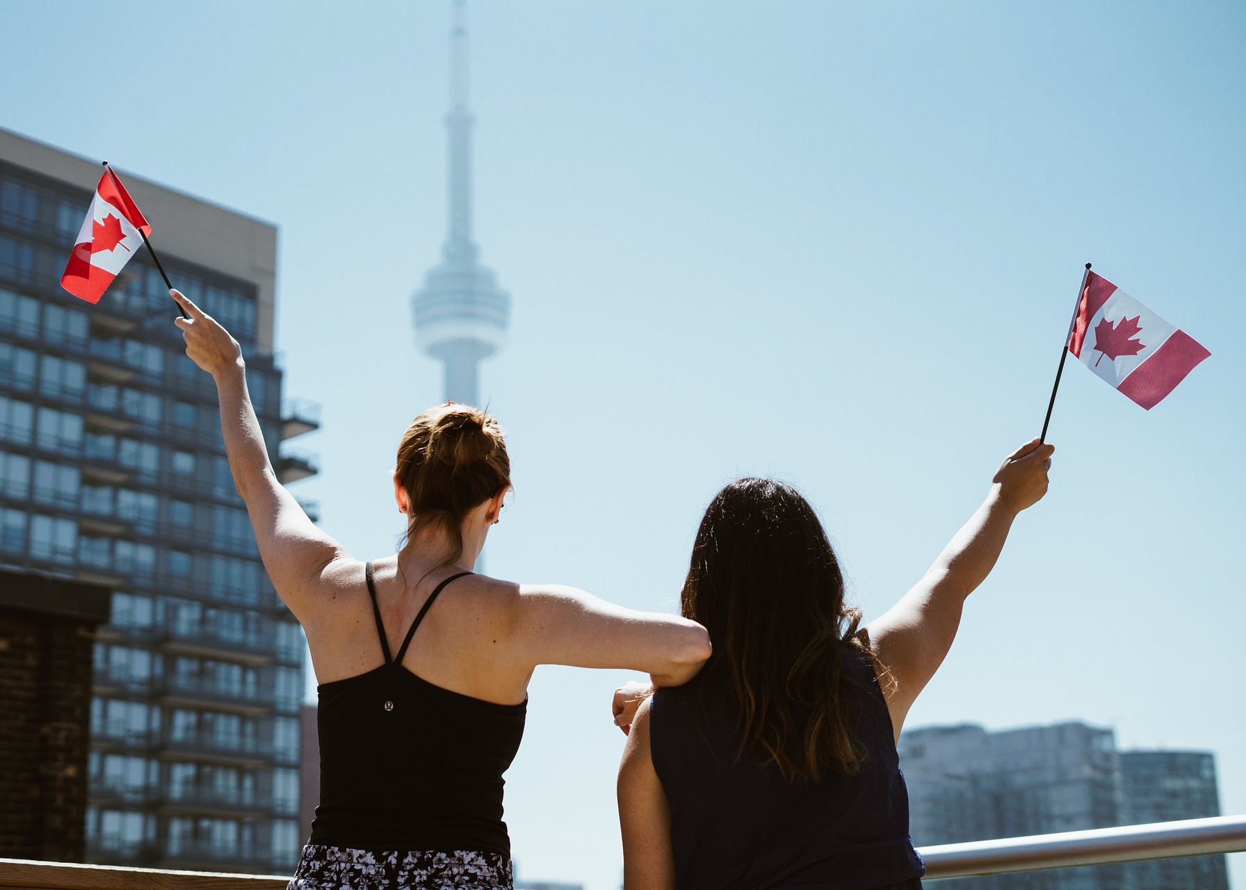 Canada Day, two women waving canadian flags