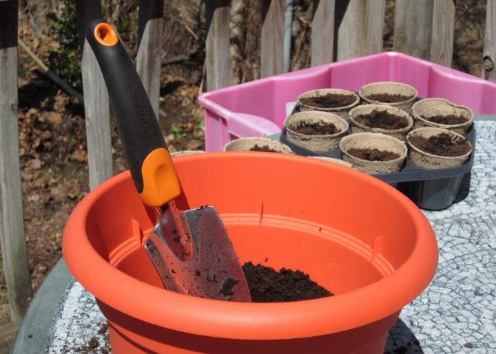 Potting soil in a pot with a shovel
