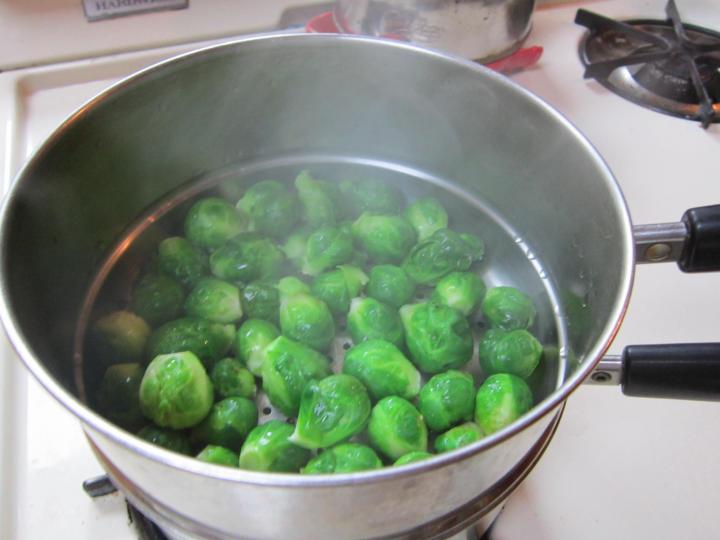 brussels sprouts in a pot being steamed prior to freezing them