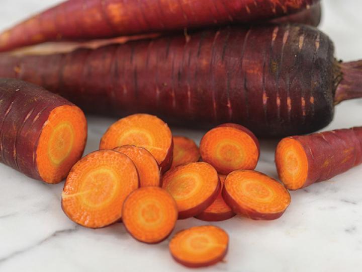Cosmic Purple Carrot by Baker Creek Heirloom Seeds. Carrots have bright purple skin and flesh that comes in shades of yellow and orange. Spicy and sweet-tasting roots.
