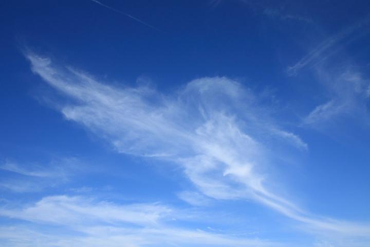 wispy white Cirrus Clouds in a blue sky