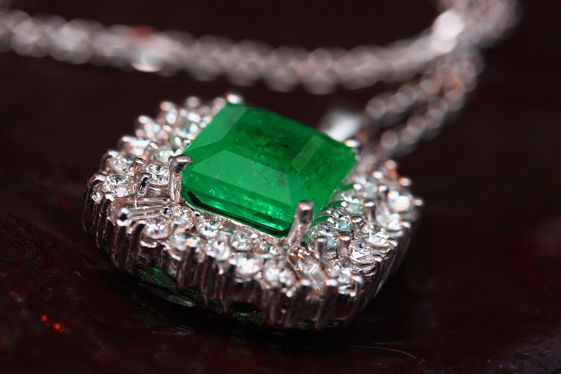 emerald pendant surrounded with diamonds