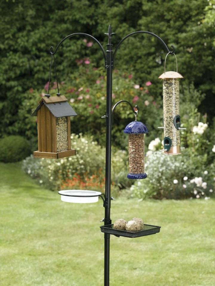 a bird feeder hook with multiple bird feeders on it